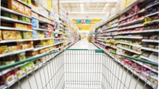 Trolley in supermarket aisle