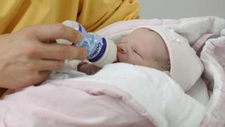 A baby being bottle-fed, file pic