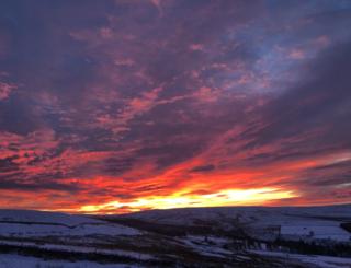 Sunset over snowy fields