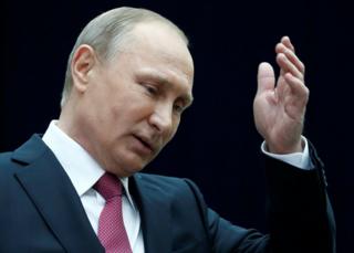 Russian President Vladimir Putin gestures as he speaks to journalists following a live nationwide broadcast call-in in Moscow, 15 June