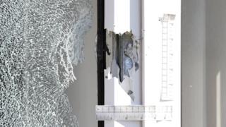 A bullet hole in a window frame