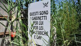 A sign at the beach at Chioggia boasts of toilets "for him, for her, for lesbians and gays"