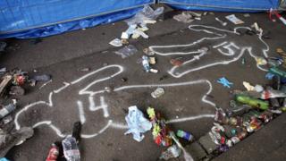 Outlines of bodies drawn on the pavement at the entrance to the tunnel where panic broke out during the Love Parade techno music festival in Duisburg on 25 July 2010