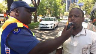 A road block operation in Rosebank, Johannesburg where a passenger is being checked for alcohol levels