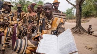 Koko Lunda Kamosi, a spiritual leader of the "Eglise des Noirs" also known as the The Messengers of the Ancestors, shows a collections of writing in Nati-Kongo with its 23 letters alphabet at a gathering outside Kinshasa