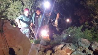 Xisco Gracia being helped from the cave by two rescuers