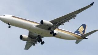 This photograph taken on 4 May 2014 shows a Singapore Airlines (SIA) aircraft approaching Changi International Airport in Singapore