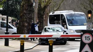 Russian diplomats and family members leave in a bus from the Russian Embassy