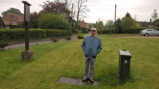 Raymond Moreton stands by the junction box in his garden