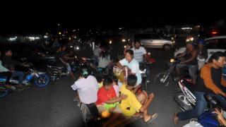 Indonesian residents use a variety of transport options as they rush to higher ground in Padang