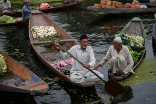 Kashmiri boatmen at the floating vegetable market on Dal lake in Srinagar