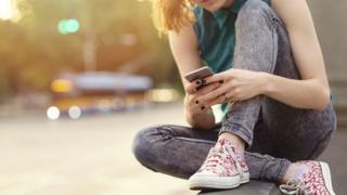 young woman looking at her phone