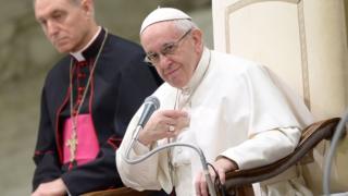 Pope Francis (R) attends his weekly general audience inside the Nervi Hall at the Vatican on February 15, 2017