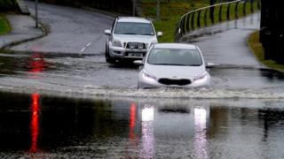 Motorists driving through the flooded Irishtown Road in Omagh