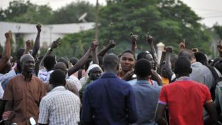 People gather at the Place de la Nation in Ouagadougou on 16 September 2015, a few hours after Burkina Faso's interim president and prime minister were detained at the presidential palace by guards loyal to ousted leader Blaise Compaore