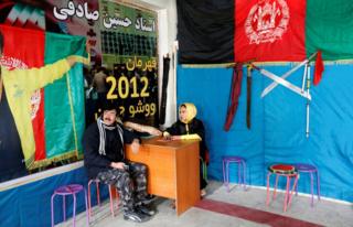 Sima Azimi, a trainer at the Shaolin Wushu club, talks with her father Rahmatullah Azimi, in Kabul, Afghanistan