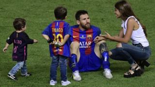 Lionel Messi joined on the pitch by Antonella Roccuzzo and their two sons