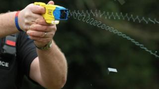 Police officer using a Taser