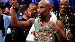 Floyd Mayweather Jr. celebrates with the belt after winning the fight against Conor McGregor (not shown) in Las Vegas, Nevada, U.S. on 26 August 2017.