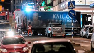 The truck (bottom, blue) that crashed into the Ahlens department store at Drottninggatan in central Stockholm