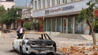 This photo taken on March 10, 2017 shows the remains of a burnt car left on a street in Lauk kai, along the China-Myanmar border in the northern Shan State of Myanmar.