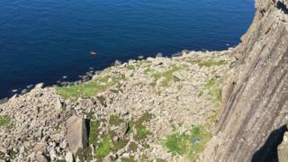The lifeboat and coastguard rescue officers applying first aid to the woman at the scene