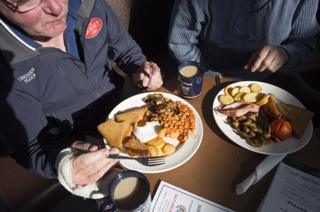 Two men eat a fry-up