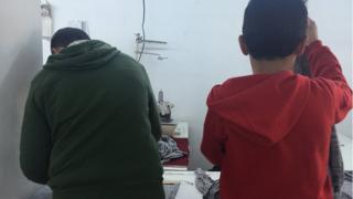 Syrian children Abdurrahman, 15, and Mohammed, 13, at work in an Istanbul garment factory