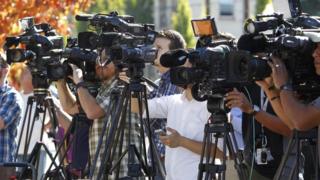 Television media cover a news conference in Roseburg, Oregon October 2, 2015