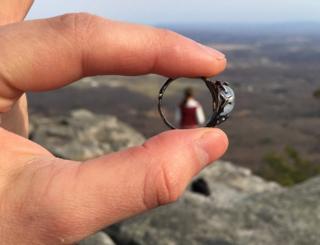 A close up of the ring, with Meg in the far distance seen through the middle of it