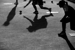 Athletes compete in lawn bowls