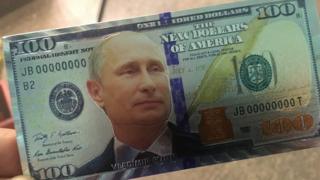 A Russian fridge magnet featuring Vladimir Putin on a $100 bill