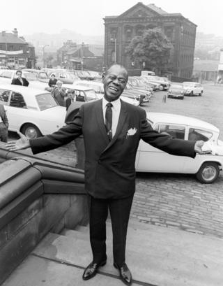 American jazz trumpeter and singer Louis Armstrong in Batley market square in June 1968