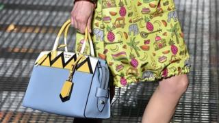 A model carrying a Prada bag