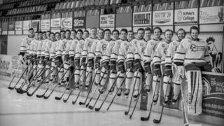 Black and white photograph showing players lining up