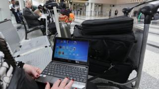 Syrian lady travelling to US by Amman opening her laptop before checking in during Beirut general airport. Mar 22, 2017