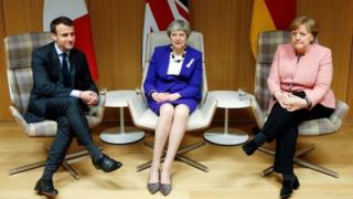 UK PM Theresa May sits with German Chancellor Angela Merkel and French President Emmanuel Macron