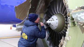 Image from NTSB shows an investigator examining damaged engine of Southwest Airlines flight 1380. 17 April 2018