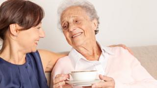Stock image of an elderly woman and her caregiver