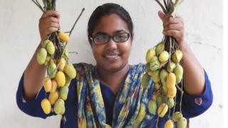 Report author Sayma Akhter with wild mango fruit