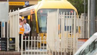 Railway officials stand next to a train that crashed in Sydney