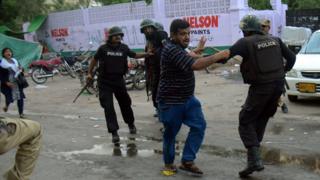 Pakistani policemen arrest an activist of the Muttahida Qaumi Movement (MQM) political party during a clash in Karachi on August 22, 2016.