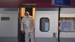 Police inspect a crime scene inside a Thalys train of French national railway operator SNCF at the main train station in Arras, northern France, on August 21, 2015