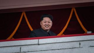 North Korea's leader Kim Jong-Un looks out towards Kim Il-Sung square during a mass military parade in Pyongyang