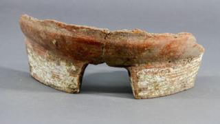 A fragment of pottery used in the brewing process.