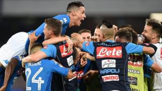 Napoli's players celebrate scoring in a Serie A game
