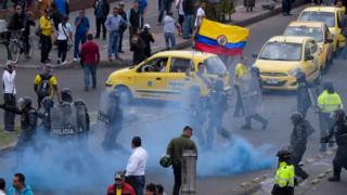 Police try to disperse taxi drivers amid protests against the private hire company Uber in Bogota, 23 October 2017