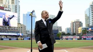 Dick Enberg waves to the crowd during a ceremony held before a baseball game between the San Diego Padres and the Los Angeles Dodgers, 29 September 2016