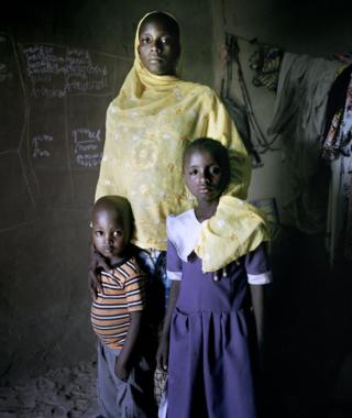 Aichadou, six, with her heavily pregnant mother Amina and four-year-old brother Ibrahim at an IDP camp for women and children, Mémé