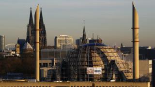 Minarets of Cologne Central Mosque are seen next to Cologne Cathedral (file pic)